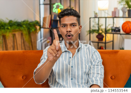 Indian man waves finger no no to camera shows refusal disagreement gesture unhappy mood clear signal Indian man waves finger no no to camera shows refusal disagreement gesture unhappy mood clear signal 134553544