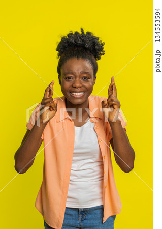 African American woman crossing fingers hopeful excited expression positive hoping wishing luck 134553594