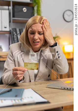 Angry mad stressed businesswoman trying to pay online shopping with blocked credit card smartphone Angry mad stressed businesswoman trying to pay online shopping with blocked credit card smartphone 134553614