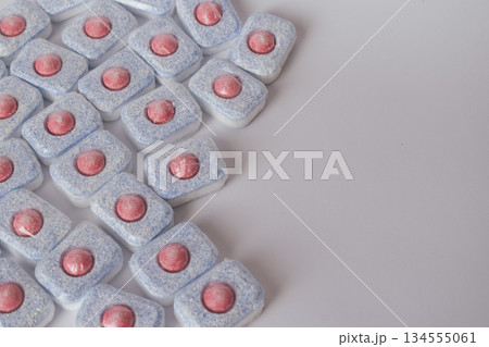 Dishwasher detergent capsules on a white background with ample copy space for text 134555061