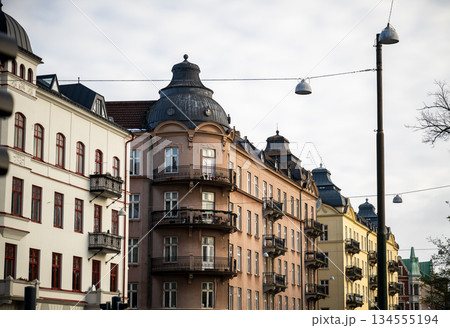 Historic European apartment buildings with ornate facades and balconies Historic European apartment buildings with ornate facades and balconies 134555194