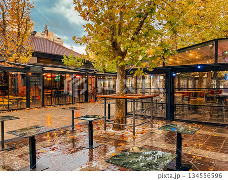 Gentle reflections on wet tables and illuminated surroundings 134556596