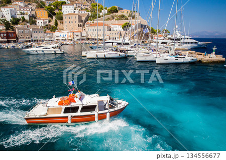 Awe  view on Boat - water taxi   at  island with harbor with ssailboats behind.   Hydra island  - best of Greek islands 134556677