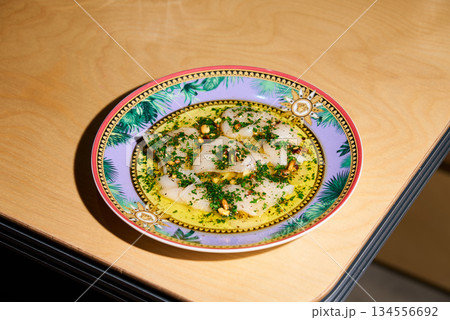 Elegant Herb Ravioli On Table, Cozy Bistro Setting Featuring Herb Ravioli And Artistic Lighting 134556692