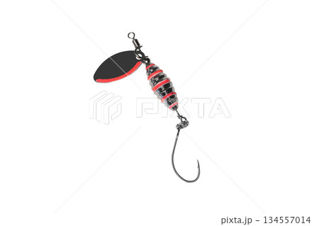 Metal fishing lure isolated on white background. Spinner lure isolated. Metal fishing lure isolated on white background. Spinner lure isolated. 134557014