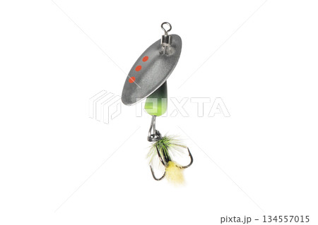 Metal fishing lure isolated on white background. Spinner lure isolated. Metal fishing lure isolated on white background. Spinner lure isolated. 134557015