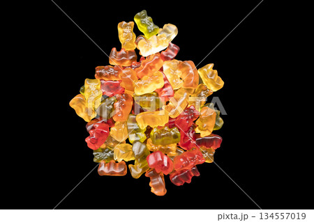 Macro shot assorted colorful gummy candies isolated on black background. Top view candy pattern. Jelly bears background texture. 134557019