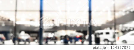 Blurred background with car dealership exterior. Abstract blurred photo of modern building motor showroom. Blur car show room office bokeh lights. Automobile retail shop Blurred background with car dealership exterior. Abstract blurred photo of modern building motor showroom. Blur car show room office bokeh lights. Automobile retail shop 134557073
