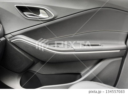 Door handle with Power window control buttons of a luxury passenger car. Black leather interior of the luxury modern car. Modern car interior details 134557083