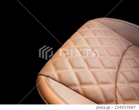 Modern luxury car brown leather interior. Part of orange leather car seat details with white stitching. Interior of prestige car. Perforated leather seats isolated. Perforated leather. 134557097