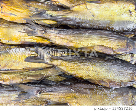 Hot smoked mackerel fish pattern. Smoke. Smoked meat. Smoked fish. Smoking room cooked at the stake. Smoked fish background texture Hot smoked mackerel fish pattern. Smoke. Smoked meat. Smoked fish. Smoking room cooked at the stake. Smoked fish background texture 134557216
