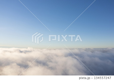 Aerial view White clouds in blue sky. Top. View from drone. Aerial bird's eye. Aerial top view cloudscape. Texture of clouds. View from above. Sunrise or sunset over clouds Aerial view White clouds in blue sky. Top. View from drone. Aerial bird's eye. Aerial top view cloudscape. Texture of clouds. View from above. Sunrise or sunset over clouds 134557247
