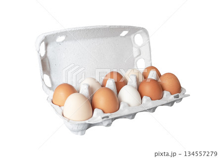 Egg tray with fresh brown eggs isolated on white background.  Fresh organic chicken eggs in carton box. 134557279
