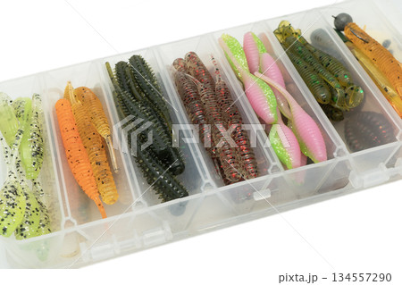 Jig silicone fishing lures in plastic tackle lure box. Silicone fishing baits isolated. Colorful baits. Fishing spinning bait. Silicone soft plastic bait lure Jig silicone fishing lures in plastic tackle lure box. Silicone fishing baits isolated. Colorful baits. Fishing spinning bait. Silicone soft plastic bait lure 134557290