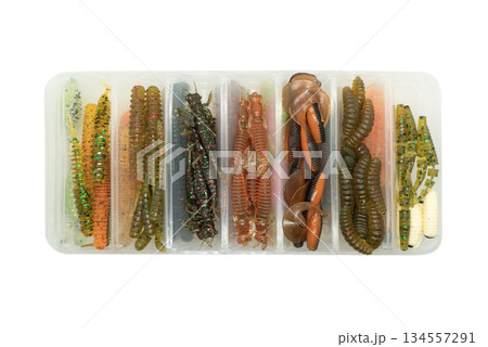 Jig silicone fishing lures in plastic tackle lure box. Silicone fishing baits isolated. Colorful baits. Fishing spinning bait. Silicone soft plastic bait lure Jig silicone fishing lures in plastic tackle lure box. Silicone fishing baits isolated. Colorful baits. Fishing spinning bait. Silicone soft plastic bait lure 134557291