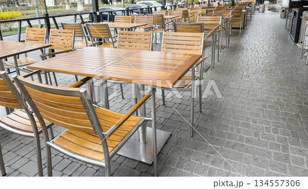 Empty stylish street cafe in a European city. Street restaurant. with terrace. Empty Cafe tables and chairs. Exterior of the cafe restaurant Empty stylish street cafe in a European city. Street restaurant. with terrace. Empty Cafe tables and chairs. Exterior of the cafe restaurant 134557306