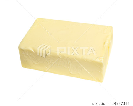 Block of natural butter isolated on white background. Butter brick isolated. Block of natural butter isolated on white background. Butter brick isolated. 134557316