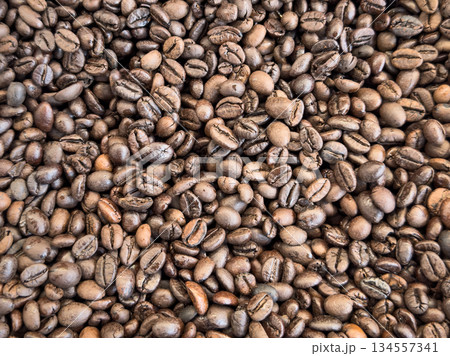 Coffee beans texture background. Brown roasted coffee beans. pattern. Closeup shot of coffee beans. Coffee beans texture background. Brown roasted coffee beans. pattern. Closeup shot of coffee beans. 134557341