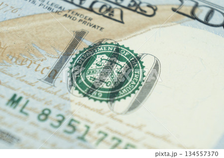 Macro shot image of the corner of a 100 dollar bill banknotes. Concept of financial success. Background of 100 dollar bills. One hundred dollars. Macro shot image of the corner of a 100 dollar bill banknotes. Concept of financial success. Background of 100 dollar bills. One hundred dollars. 134557370