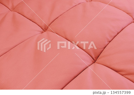 Red leather texture. Part of perforated leather details. Red perforated leather texture background. Texture, artificial leather with diagonal stitching. Red leather texture. Part of perforated leather details. Red perforated leather texture background. Texture, artificial leather with diagonal stitching. 134557399