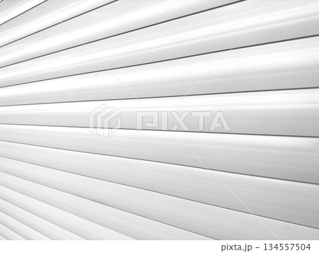 Roller shutter gate. Metal roller garage door as background. Automatic electric roll-up garage gate. Garage with white rolling gates. Roller shutter gate. Metal roller garage door as background. Automatic electric roll-up garage gate. Garage with white rolling gates. 134557504