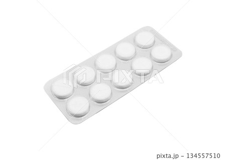 Macro shot pile of tablets pill in silver blister packaging isolated on white background. Aluminium foil blister pack. Pharmacy products. Medicine pills and drugs close up. Pills background 134557510