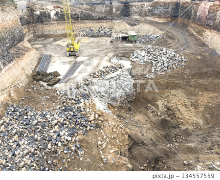 Aerial view construction site with a foundation pit of complex. pit foundation for buiding construction. Earthwork in excavation and backfilling of soil. Construction machinery for earthmoving. 134557559