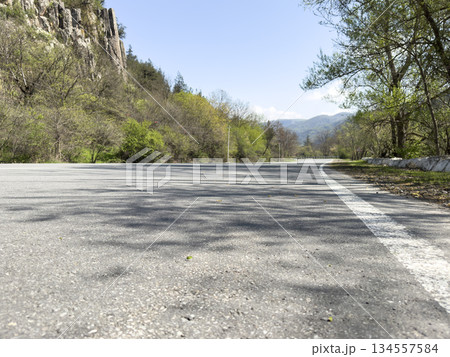 Country road in the forest and mountains. Landscape. Country road in the forest and mountains. Landscape. 134557584