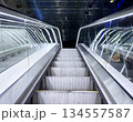 Escalators. Electric stairs in a public area. Modern automatic escalator system in shopping mall. 134557587