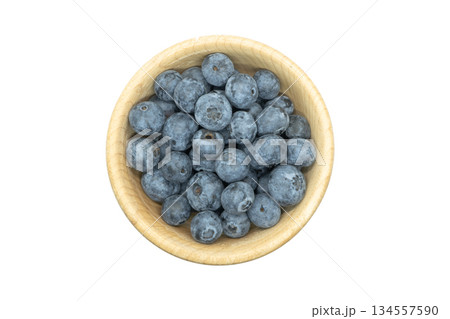Ripe sweet blueberry. Fresh blueberries isolated on white background. Macro shot texture of blueberry berries in wooden cup. Blueberry berries pattern close up Ripe sweet blueberry. Fresh blueberries isolated on white background. Macro shot texture of blueberry berries in wooden cup. Blueberry berries pattern close up 134557590