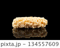 Texture of dry instant noodles isolated on black background. Raw dried Instant ramen noodles block isolated. 134557609