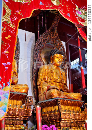 Buddhist deities in the historic Buddhist Jingan Temple on the West Nanjing Road in downtown Shanghai, China Buddhist deities in the historic Buddhist Jingan Temple on the West Nanjing Road in downtown Shanghai, China 134558332
