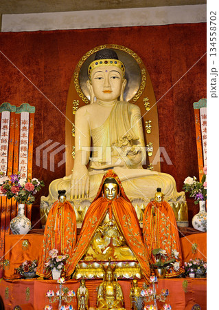 Buddhist deities in the historic Buddhist Jingan Temple on the West Nanjing Road in downtown Shanghai, China Buddhist deities in the historic Buddhist Jingan Temple on the West Nanjing Road in downtown Shanghai, China 134558702