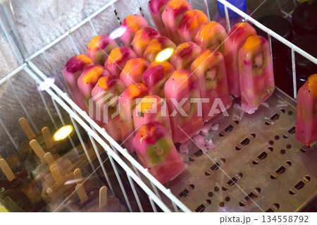 Colorful Fruit Popsicles in Freezer Colorful Fruit Popsicles in Freezer 134558792
