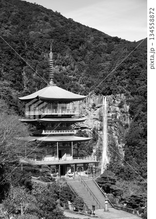Three story pagoda of Seiganto-ji Tendai Buddhist temple in Wakayama Prefecture, Japan with Nachi Falls in the background 134558872