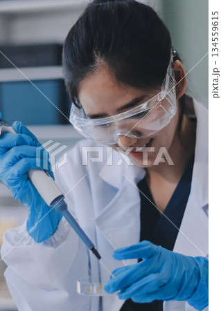 Portrait, science and happy woman on laptop in lab to research chemistry, test or innovation. Microscope, scientist and face of medical doctor in goggles for microbiology, healthcare or pharma study 134559615