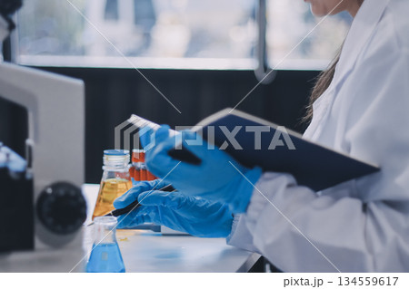 Portrait, science and happy woman on laptop in lab to research chemistry, test or innovation. Microscope, scientist and face of medical doctor in goggles for microbiology, healthcare or pharma study 134559617