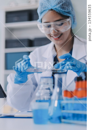 Portrait, science and happy woman on laptop in lab to research chemistry, test or innovation. Microscope, scientist and face of medical doctor in goggles for microbiology, healthcare or pharma study Portrait, science and happy woman on laptop in lab to research chemistry, test or innovation. Microscope, scientist and face of medical doctor in goggles for microbiology, healthcare or pharma study 134559635