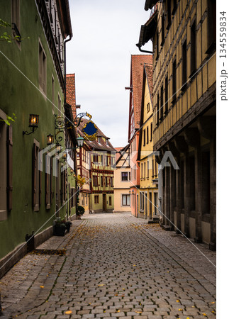 Narrow medieval street with half timbered houses in Rothenburg ob der Tauber 134559834