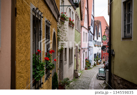 Charming medieval alley with colorful houses in Rothenburg ob der Tauber old town 134559835