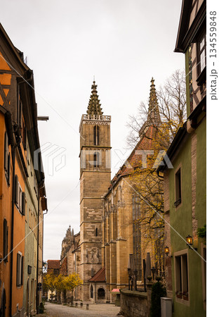 Gothic church tower on medieval street in Rothenburg ob der Tauber old town 134559848