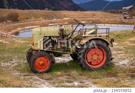 Vintage tractor on alpine pasture with mountain landscape 134559852