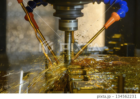 The CNC milling machine rough cutting the mold parts with oil coolant method. 134562231