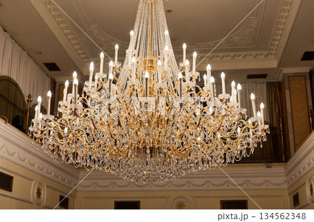 Grand Room With Sparkling Chandelier, Luxurious Hall Illuminated By Dazzling Crystal Fixture 134562348