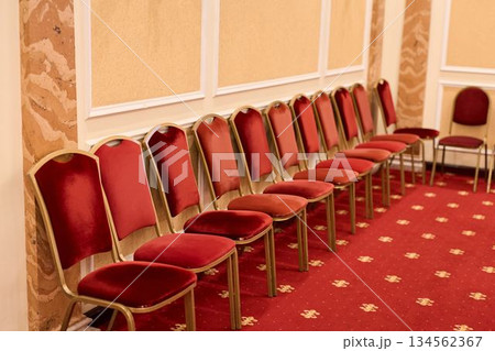 Elegant Ballroom With Red Seating, Charming Hall Featuring Plush Carpets And Golden Accents 134562367