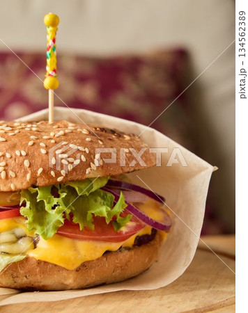 Quick snack packed in parchment, Convenient street food burger wrapped with parchment and ingredients Quick snack packed in parchment, Convenient street food burger wrapped with parchment and ingredients 134562389