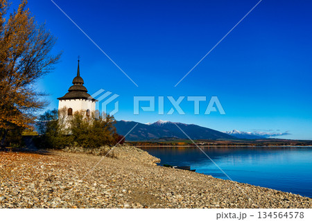 Old church tower of Havranok by Liptovska Mara lake with Tatra mountains in autumn 134564578