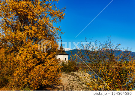 Old church tower of Havranok by Liptovska Mara lake with Tatra mountains in autumn 134564580