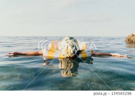 Woman Float Sea Relaxing on Inflatable Ring - Summer Vacation 134565296