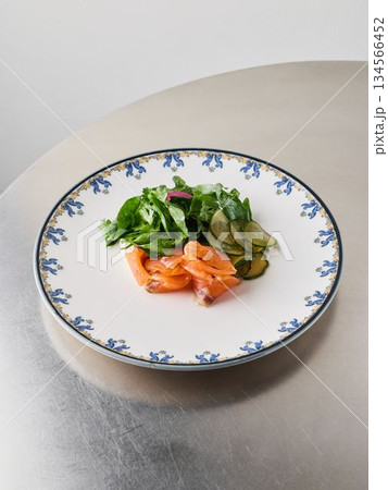 Sophisticated plate featuring smoked salmon and fresh vegetables Sophisticated plate featuring smoked salmon and fresh vegetables 134566452